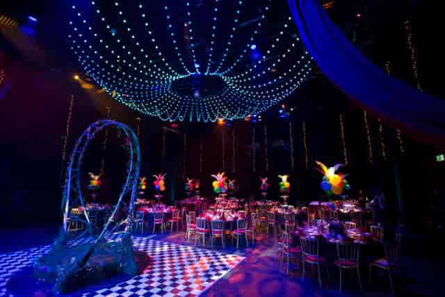 Elegant gala event space with round tables and vibrant decor at Birmingham REP.