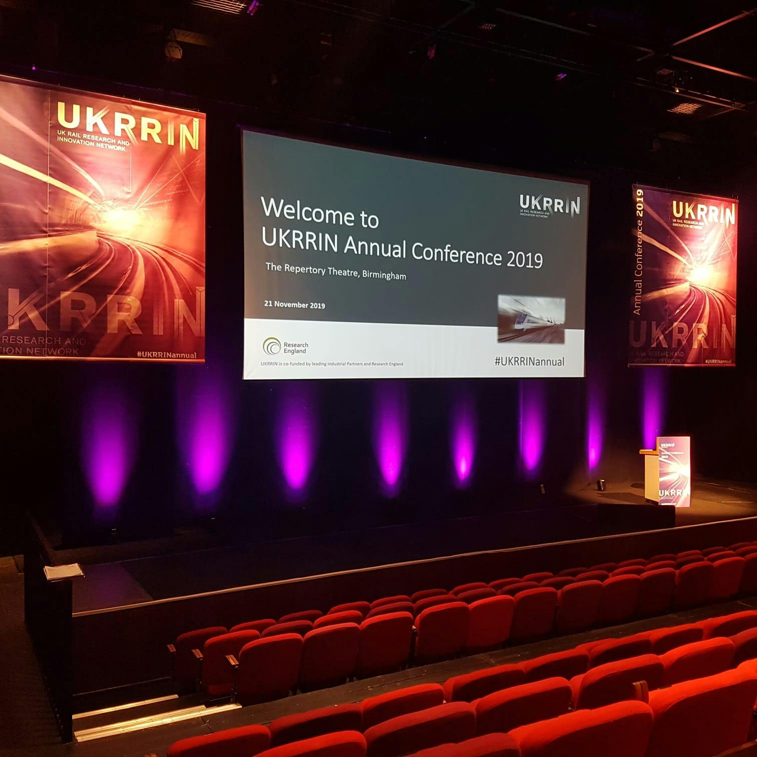 Conference setup at Studio Theatre, Birmingham REP; vibrant branding, ideal for presentations.