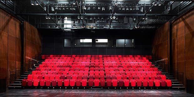 Modern auditorium with red seating for conferences and performances in Birmingham.