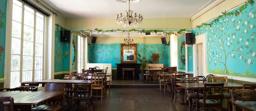 The Colonel Fawcett private function room with stage for events and networking.