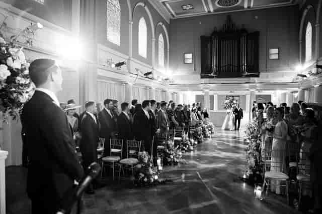 Elegant wedding ceremony in Soane Hall, featuring floral decor and romantic lighting.