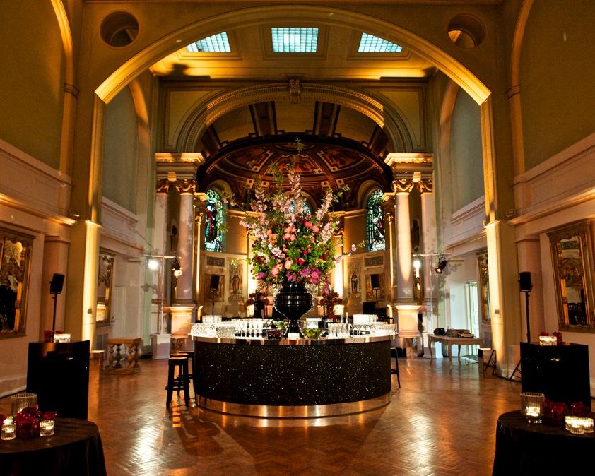 Soane Hall event space with high ceilings and floral bar arrangement for elegant gatherings. - Banner