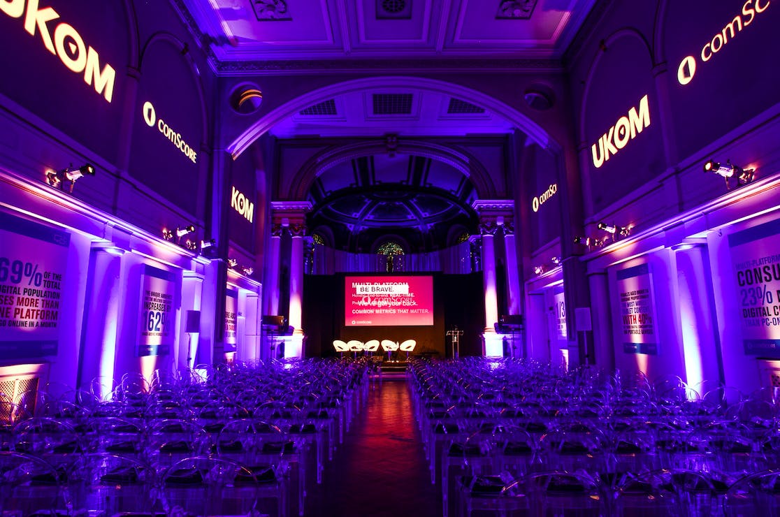 Soane Hall conference setup with clear chairs and purple lighting for engaging events.