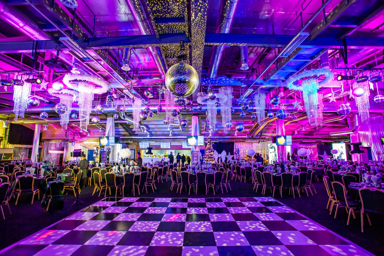 Gala setup with purple lighting and dance floor at Edgbaston Stadium exhibition venue.