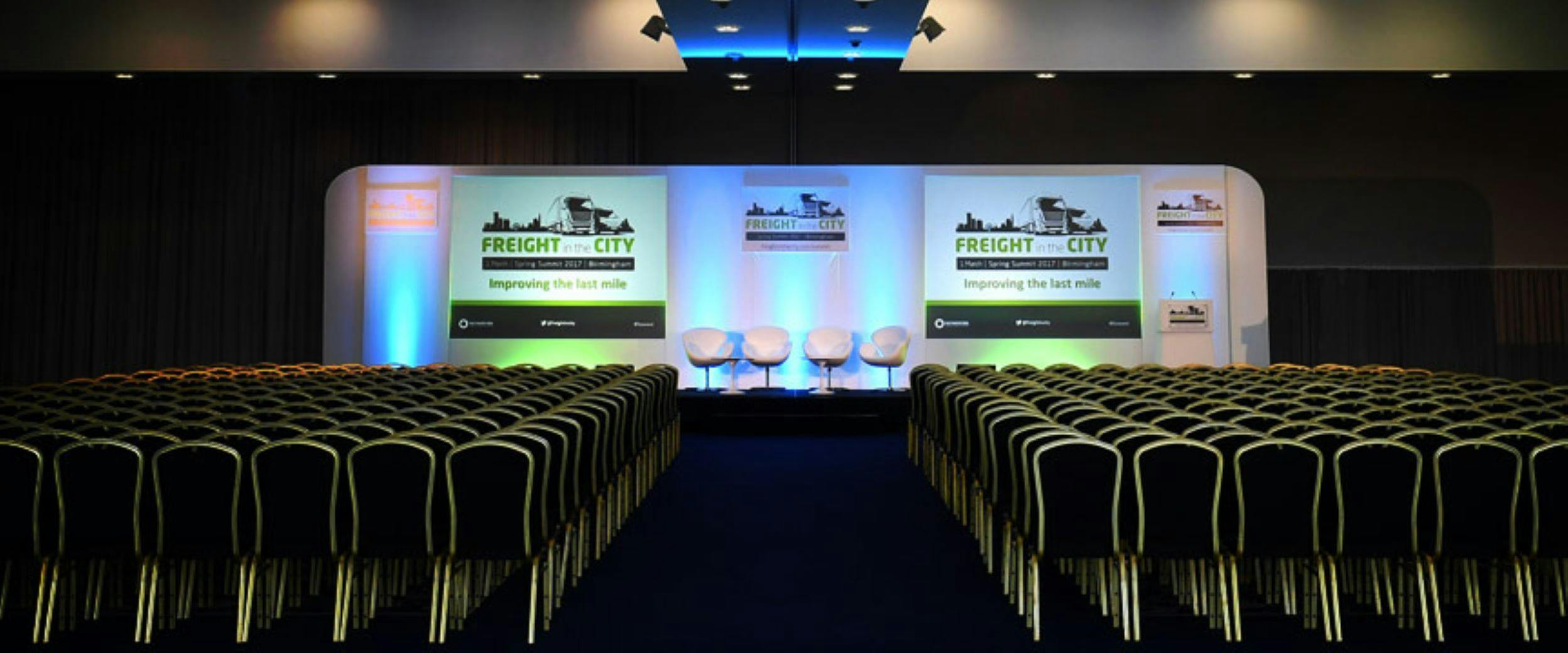 Banqueting Suite at Edgbaston Stadium, conference setup with stage and branding.