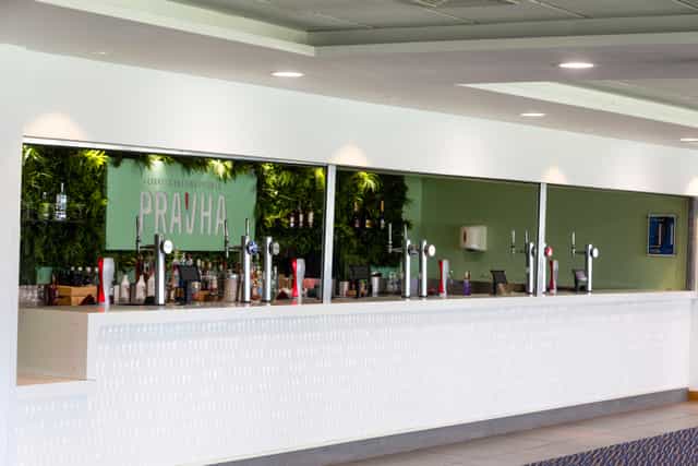 1882 Suite bar at Edgbaston Stadium with green feature wall for corporate events and conferences.