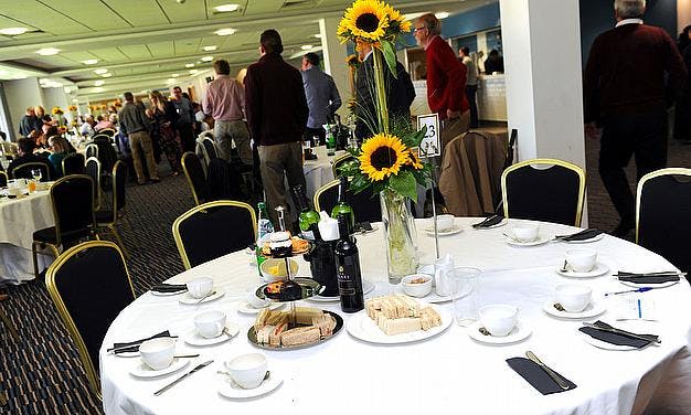 Elegant 1882 Suite at Edgbaston Stadium, vibrant sunflower centerpiece for networking event.