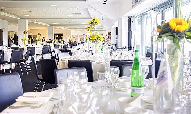 Warwickshire Suite at Edgbaston Stadium, elegant tables set for formal networking events.