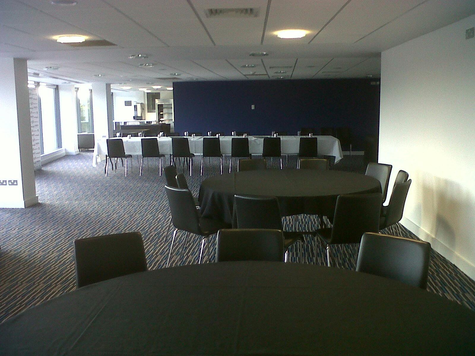 Press Lounge at Edgbaston Stadium: versatile event space with round tables for meetings and gatherings.