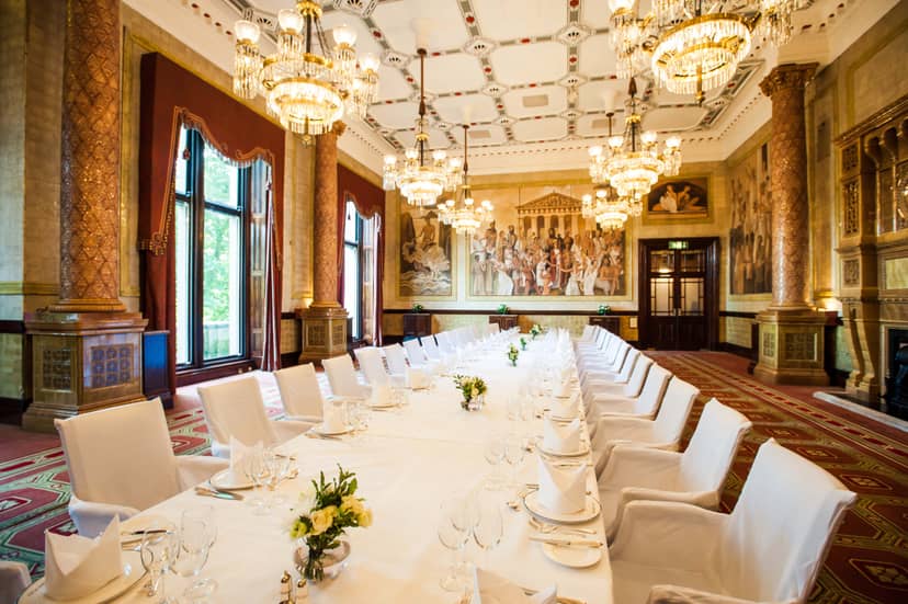 Elegant banquet hall with fine china, ideal for corporate events and formal dinners.