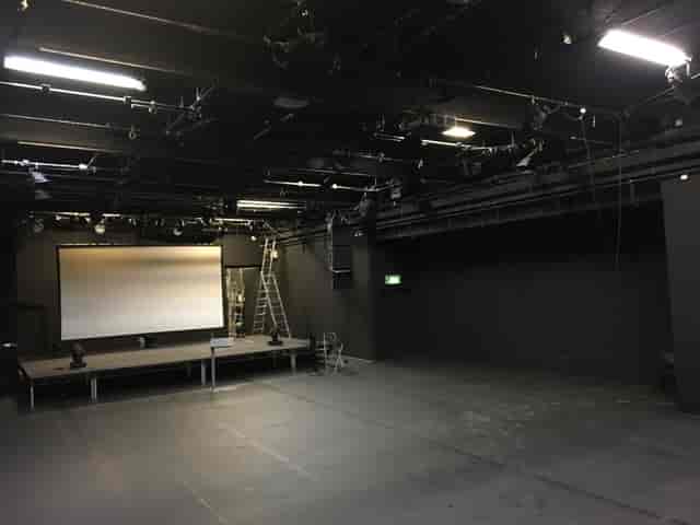 Versatile ICA Theatre with raised stage, ideal for corporate meetings and performances.