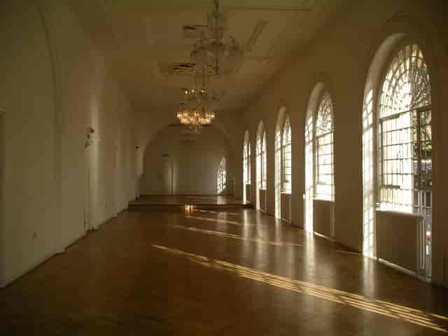 Elegant event space at One Marylebone with arched windows and chandeliers.