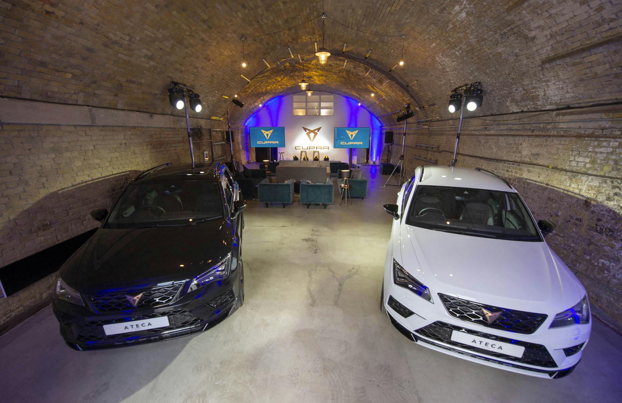 Stylish event space with sleek cars, perfect for automotive product launches.