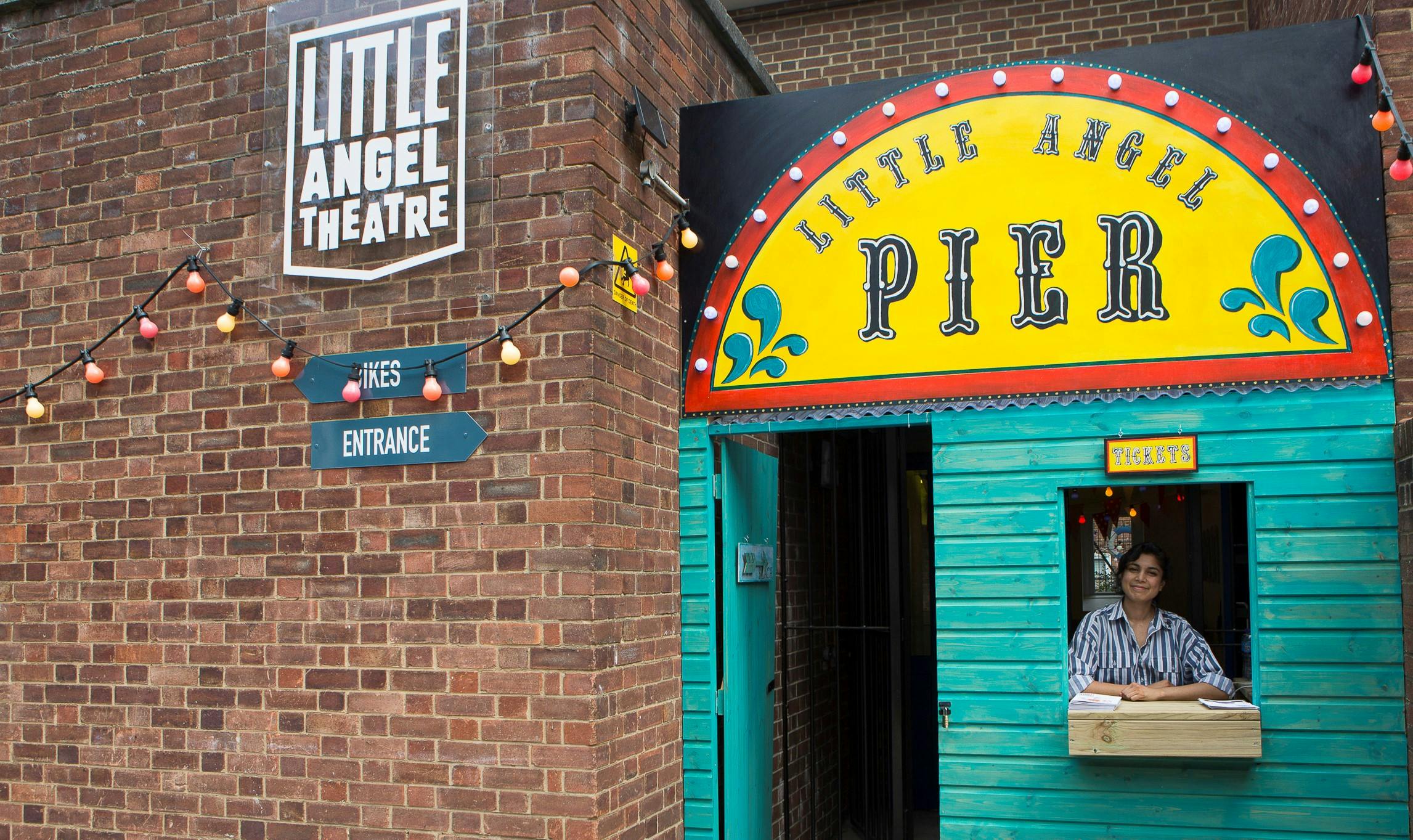 Vibrant entrance of Little Angel Theatre with colorful signage for engaging events.