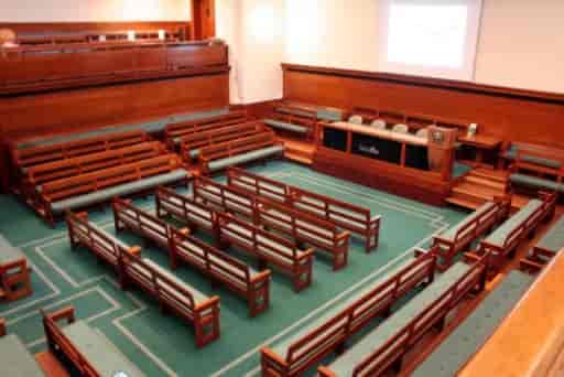 Main Meeting House at The Priory Rooms featuring fixed bench seating for formal conference events.