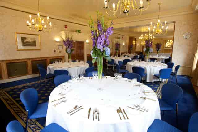 Elegant banquet room with floral centerpieces for weddings and corporate events.