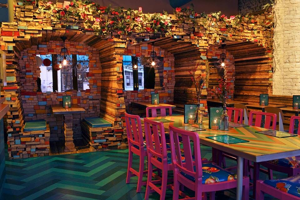 Timber Yard Shoreditch: vibrant book-themed event space with colorful decor for gatherings.