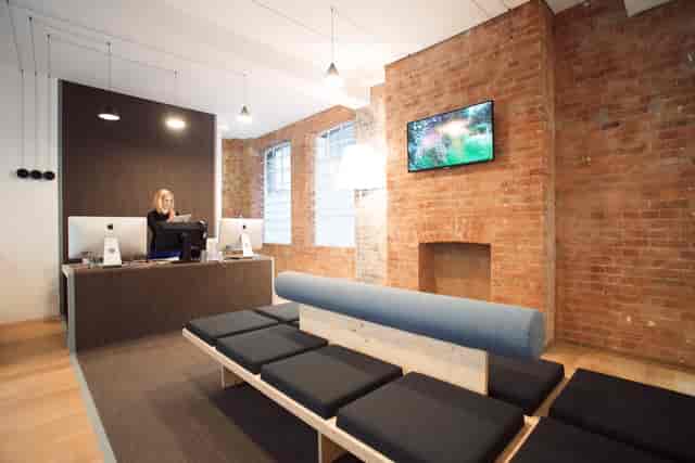 Modern reception area in Sutherland Labs with exposed brick, ideal for events and meetings.