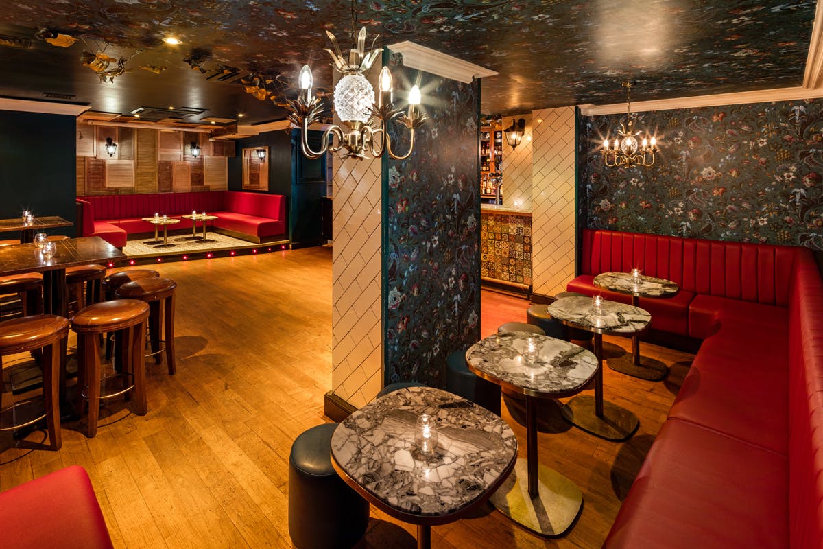 Stylish Uptown Bar in Shoreditch with plush red seating for events and gatherings.