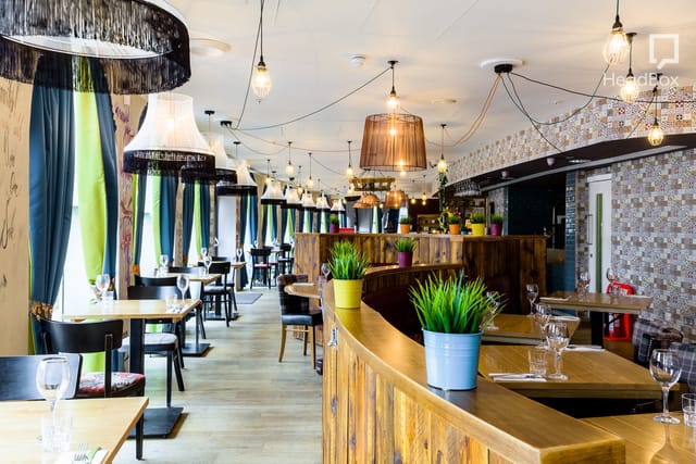 Stylish dining area at The Suites, perfect for meetings and events with cozy decor.