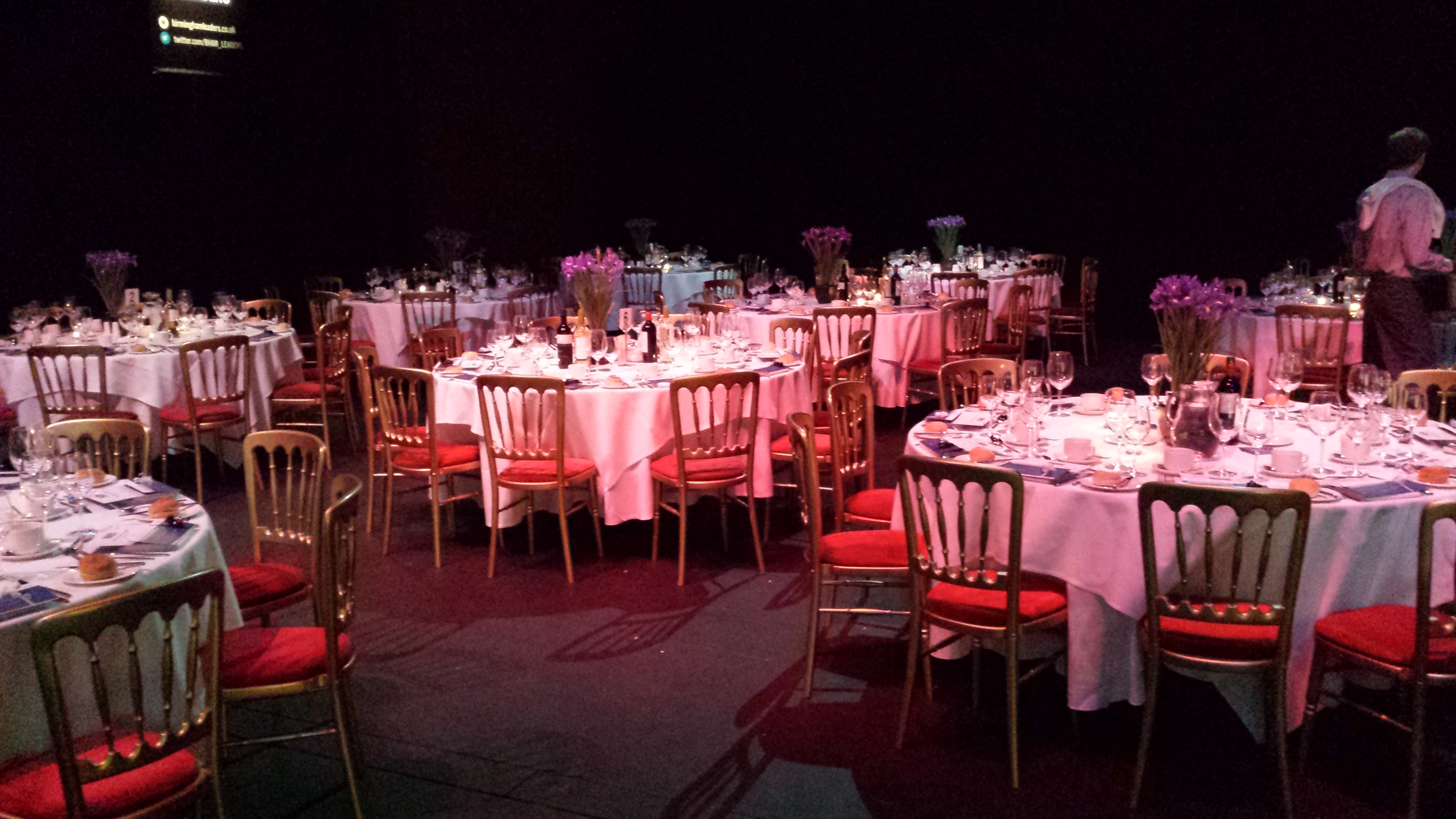 Elegant event space at Studio Theatre, round tables with floral centerpieces, gala venue.