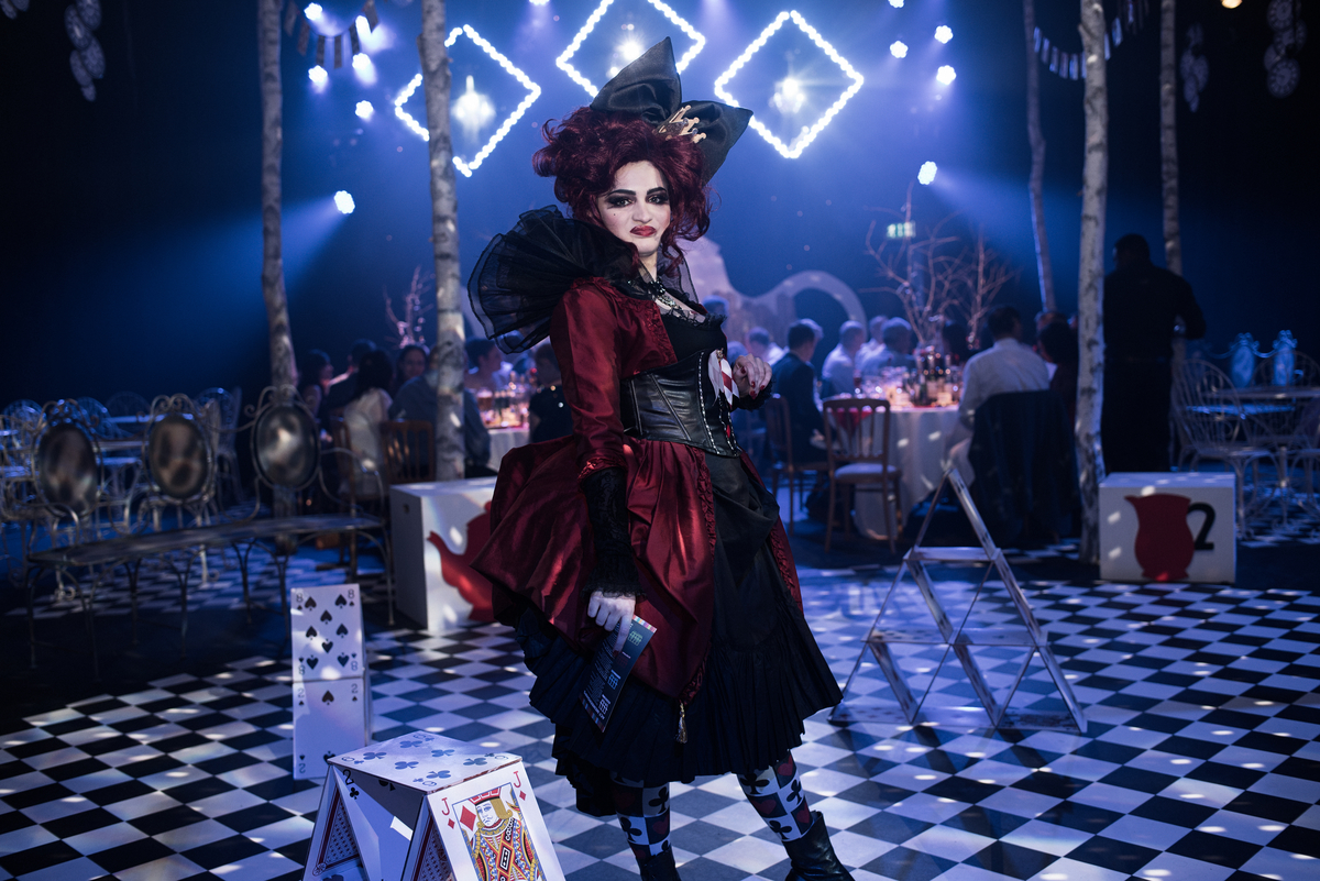 The Studio Theatre event with vibrant lighting and performer in elaborate costume. - Banner