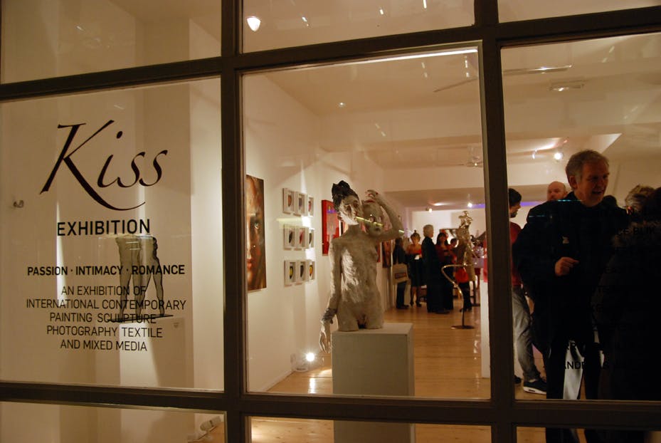 Vibrant art exhibition "Kiss" at Gallery Different, showcasing contemporary romance-themed works.