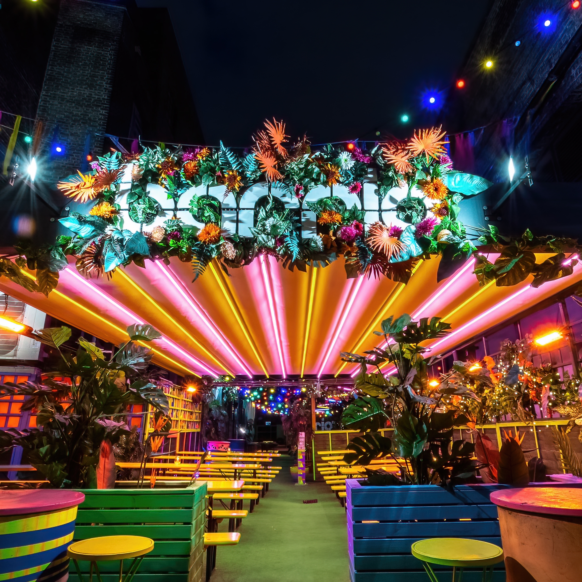 Vibrant La Terraza event space in Shoreditch with colorful floral decor and dynamic lighting. - Banner