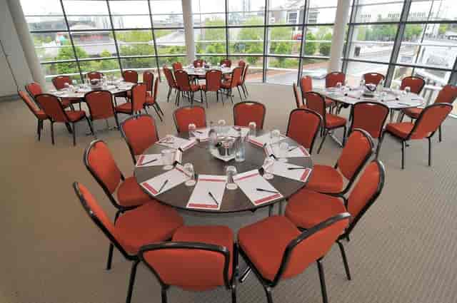 Meeting space in AC Hotel Manchester with round tables for workshops and conferences.