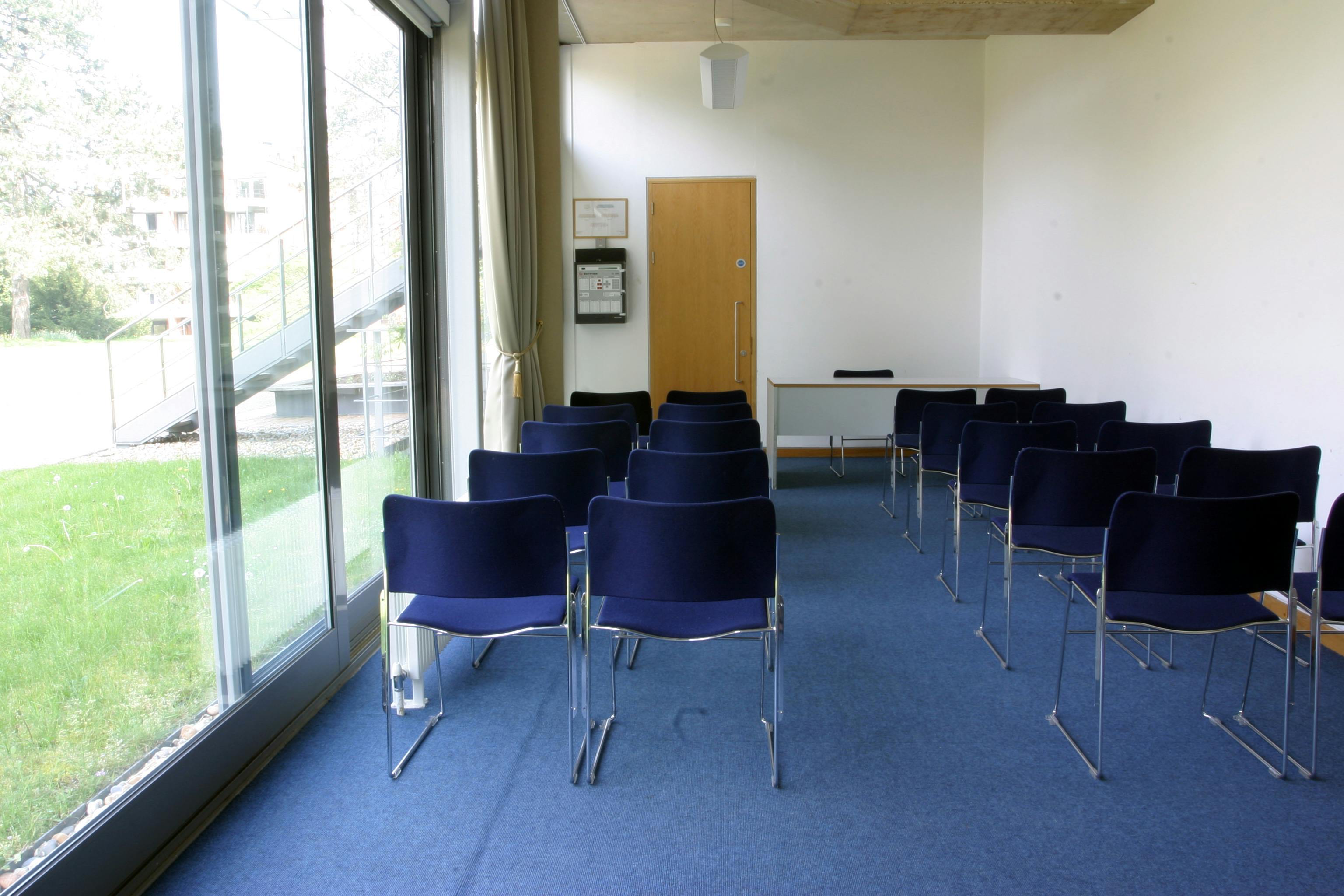 Maplethorpe Office meeting room with navy chairs, ideal for presentations and discussions.