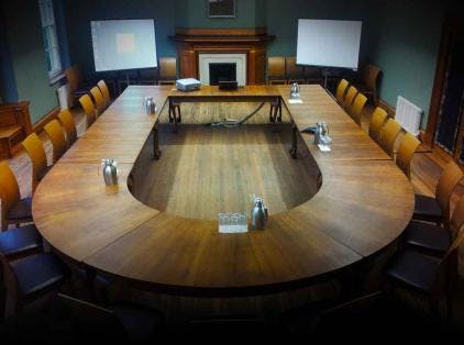 MGA Lecture Room at St Hugh's College with oval table, ideal for conferences and workshops.