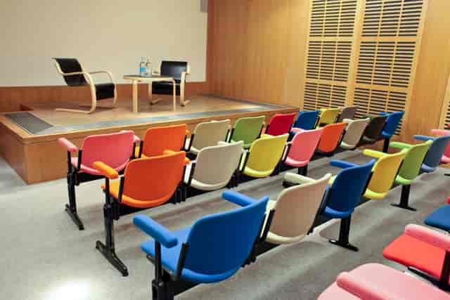 Zilkha Auditorium event space with minimalist stage, ideal for panel discussions and interviews.