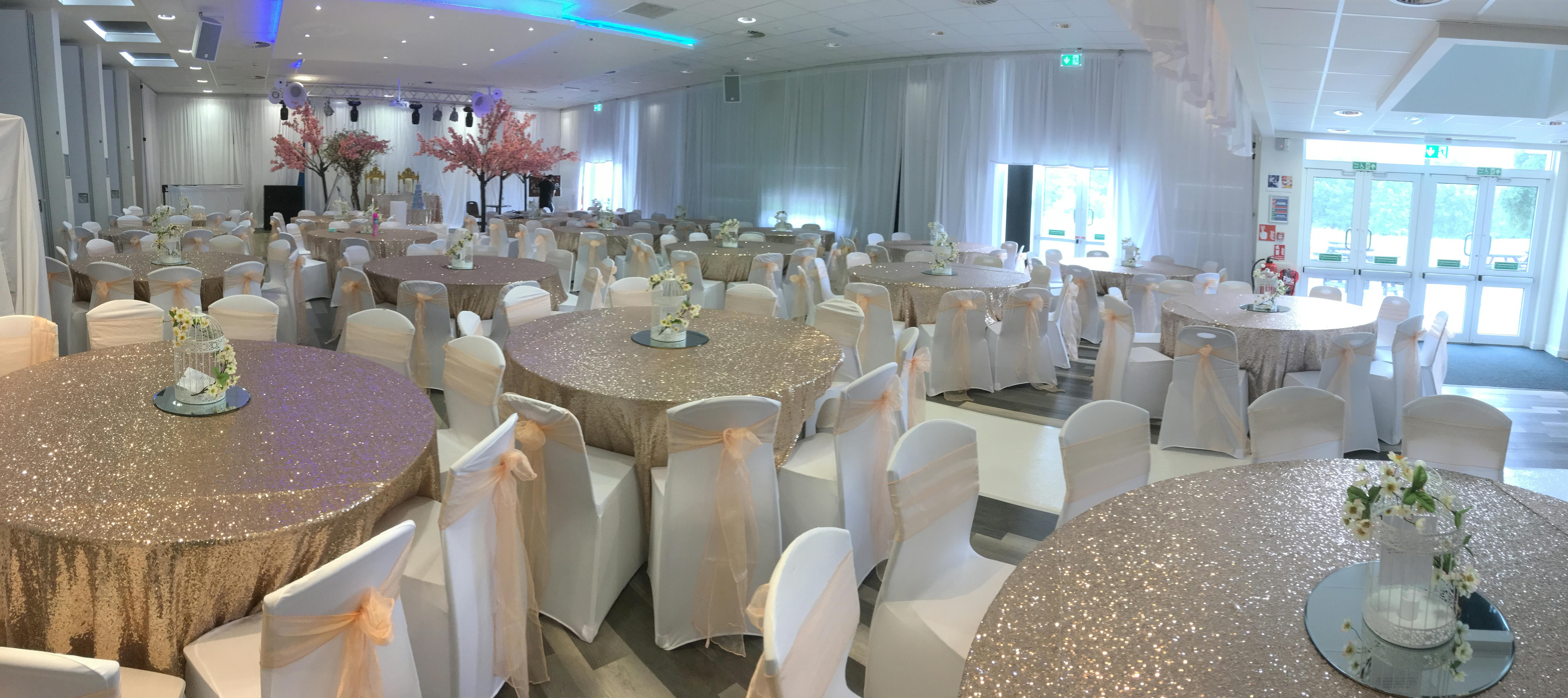 Elegant event space at Reading University with gold tables, ideal for weddings and gatherings.