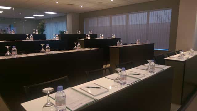 Professional meeting room with tiered seating, ready for events and discussions.