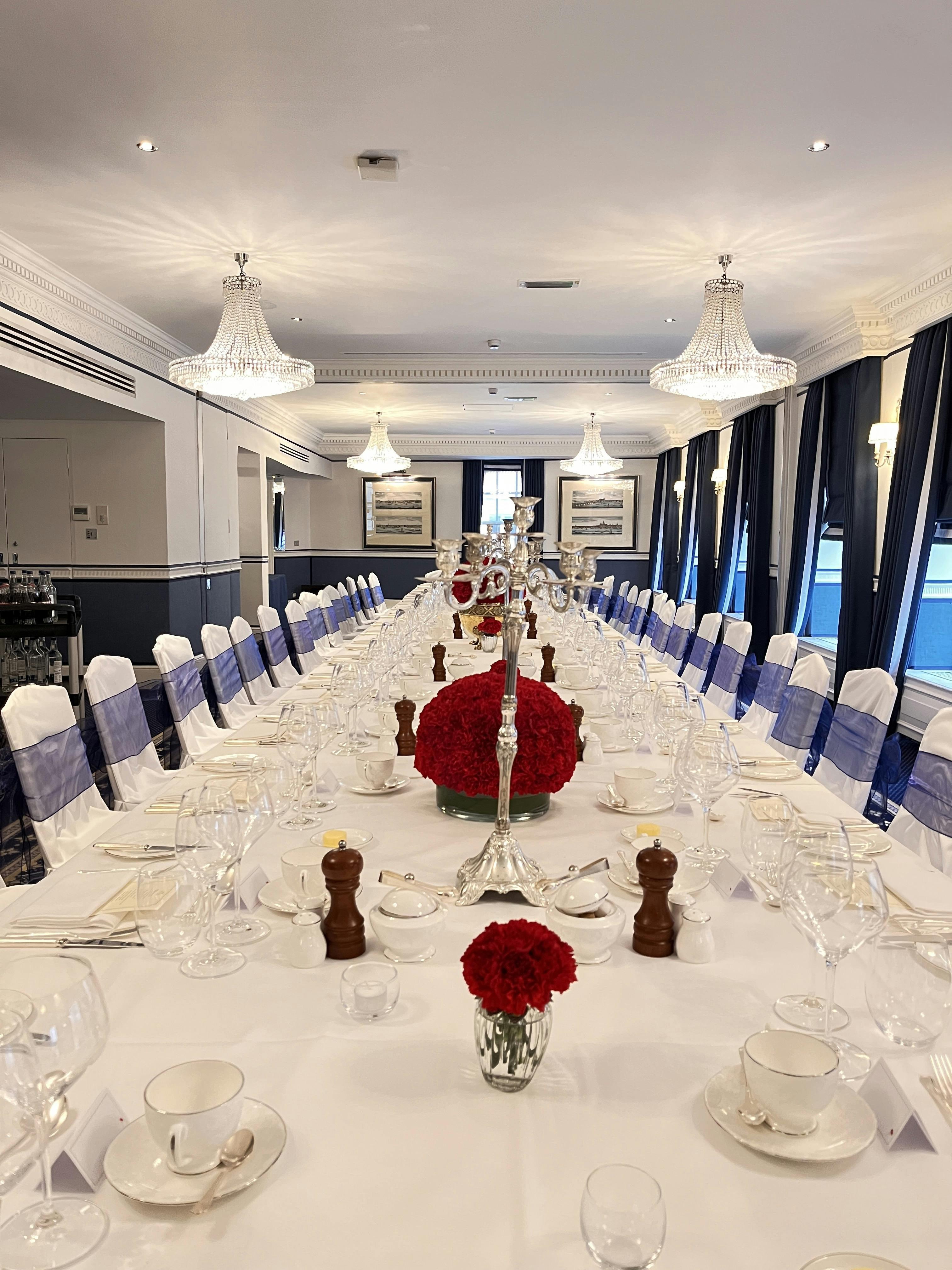 Royal Suite banquet table with red floral centerpieces for elegant events and corporate gatherings.