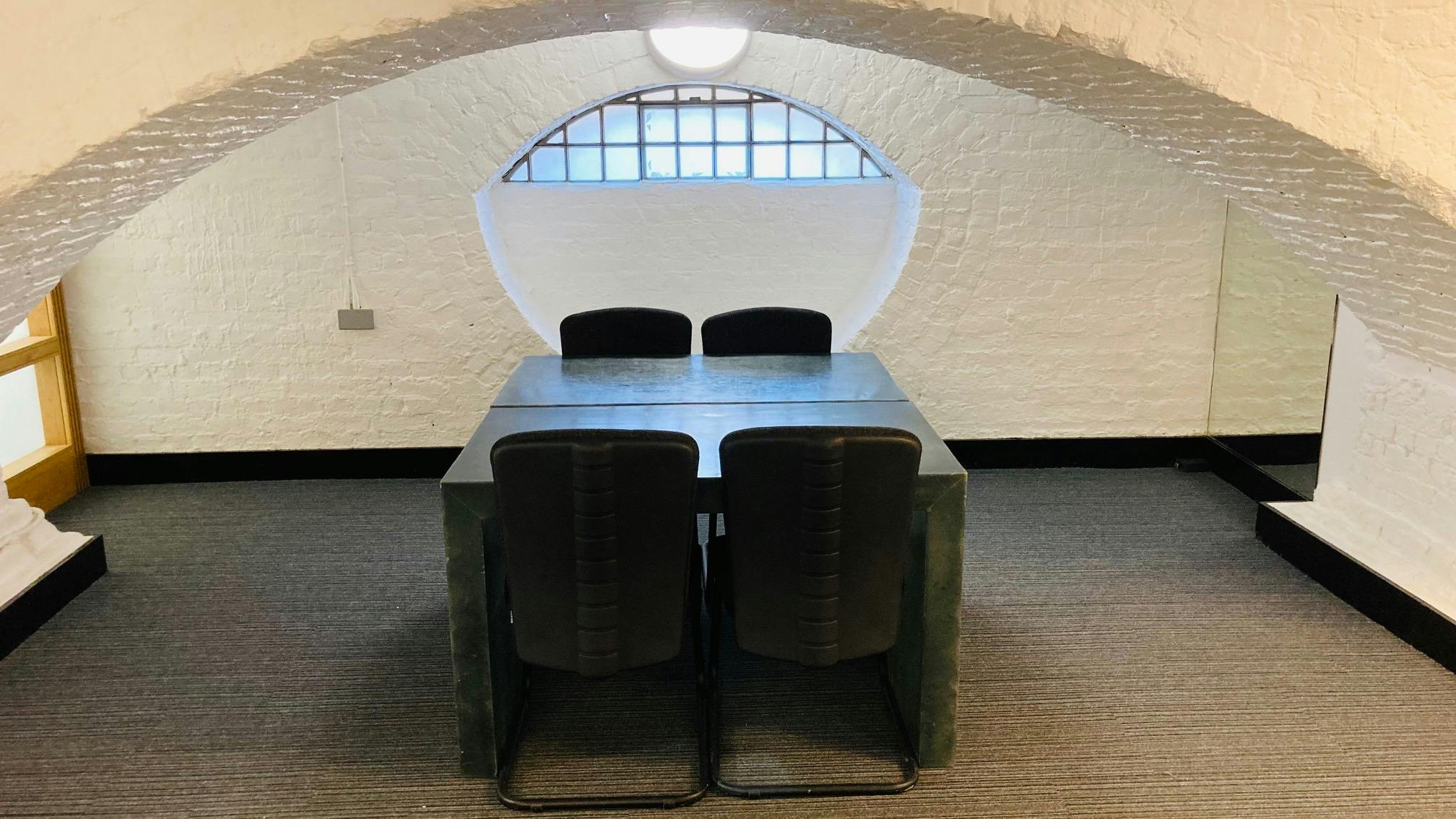 "Intimate meeting space with arched ceiling in St John's Hoxton for off-site brainstorming."