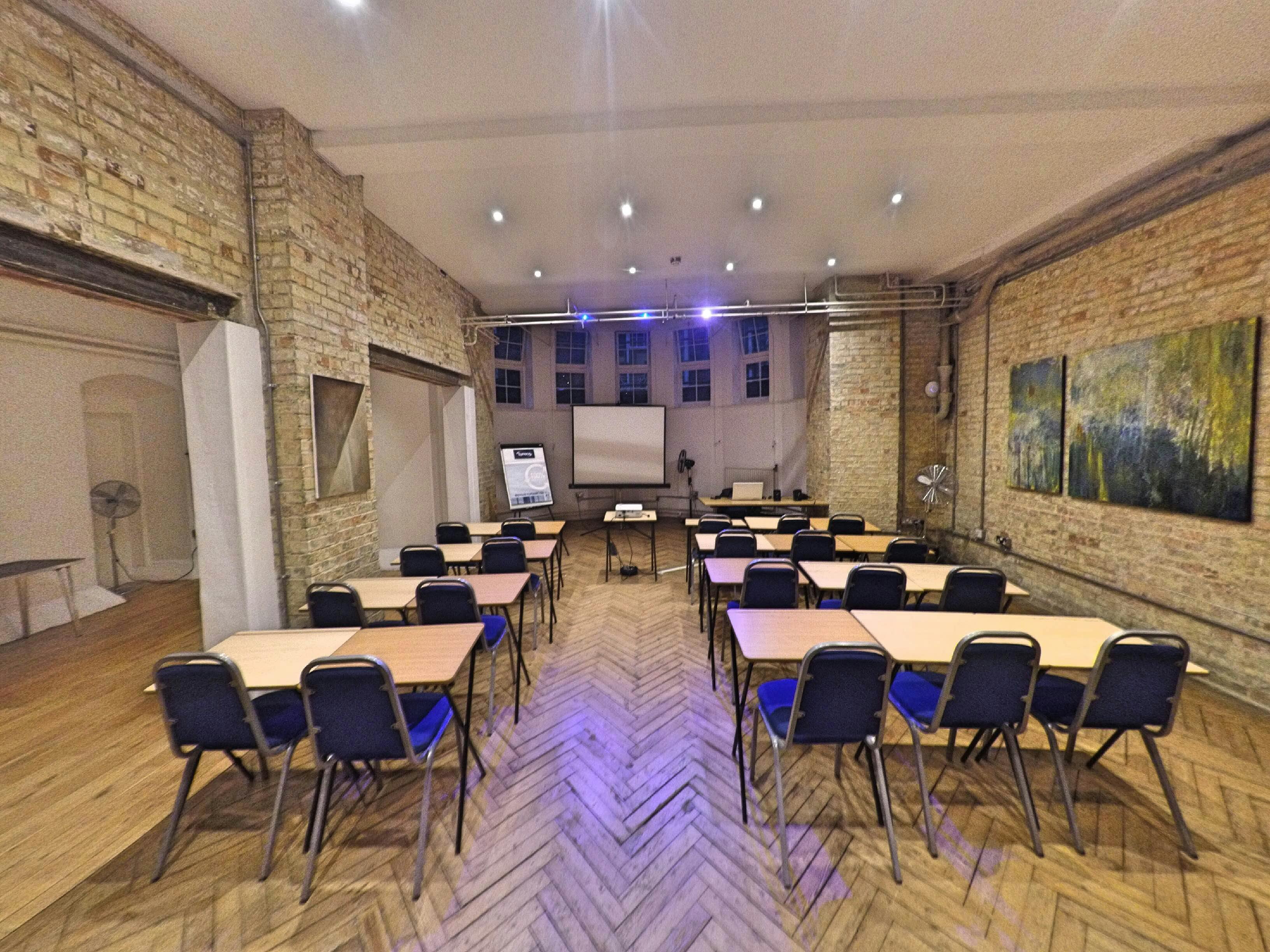 Arnold Room at Mary Ward House, a bright seminar space with wooden flooring and AV setup.