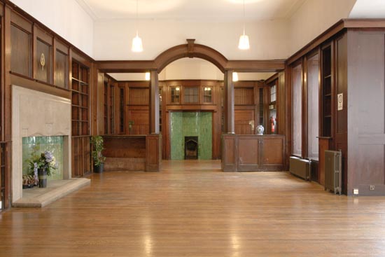 Dickens Library meeting room with wooden paneling, ideal for events and gatherings.