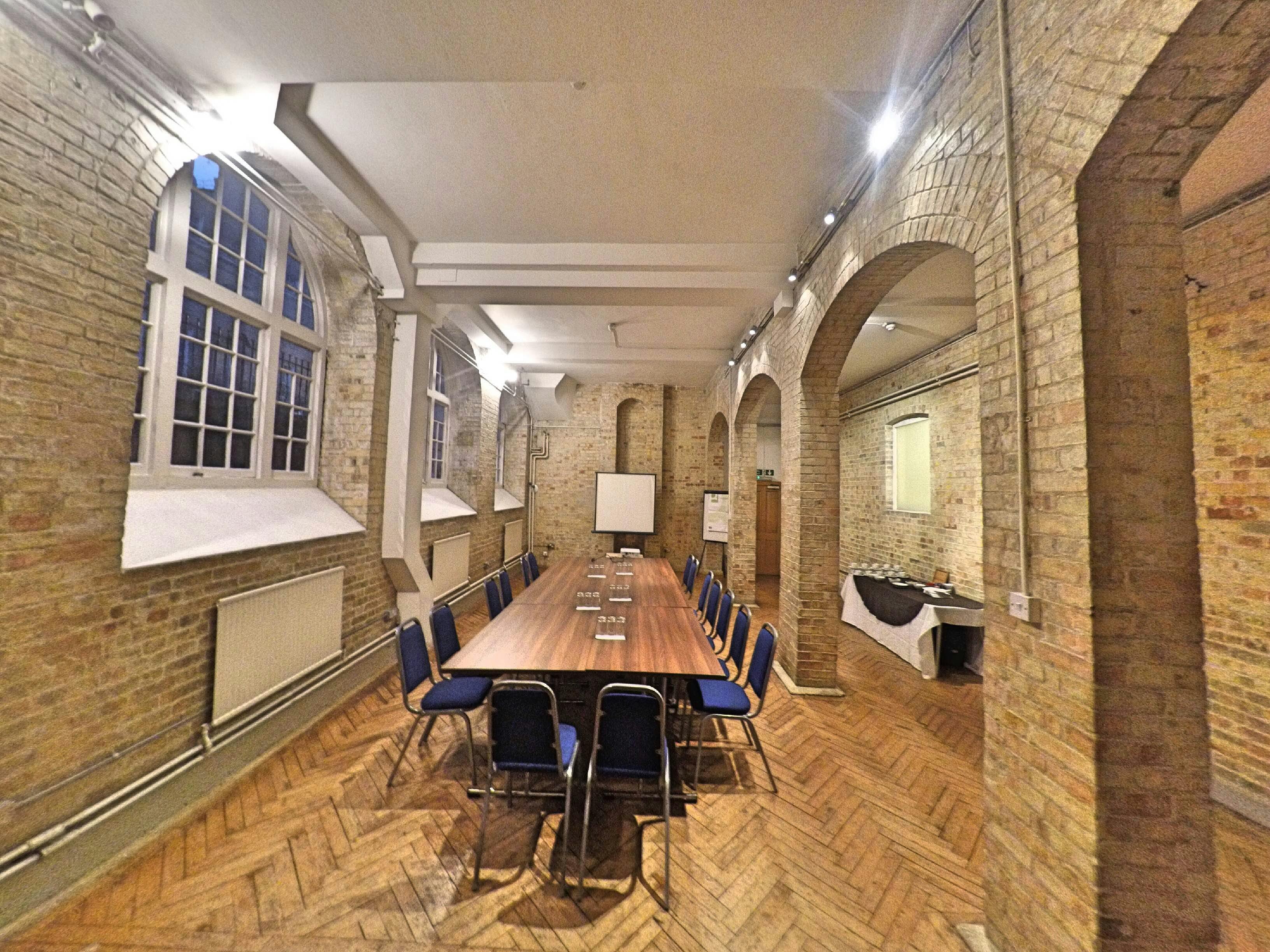 Morris Room at Mary Ward House: bright meeting space with wooden table and blue chairs.