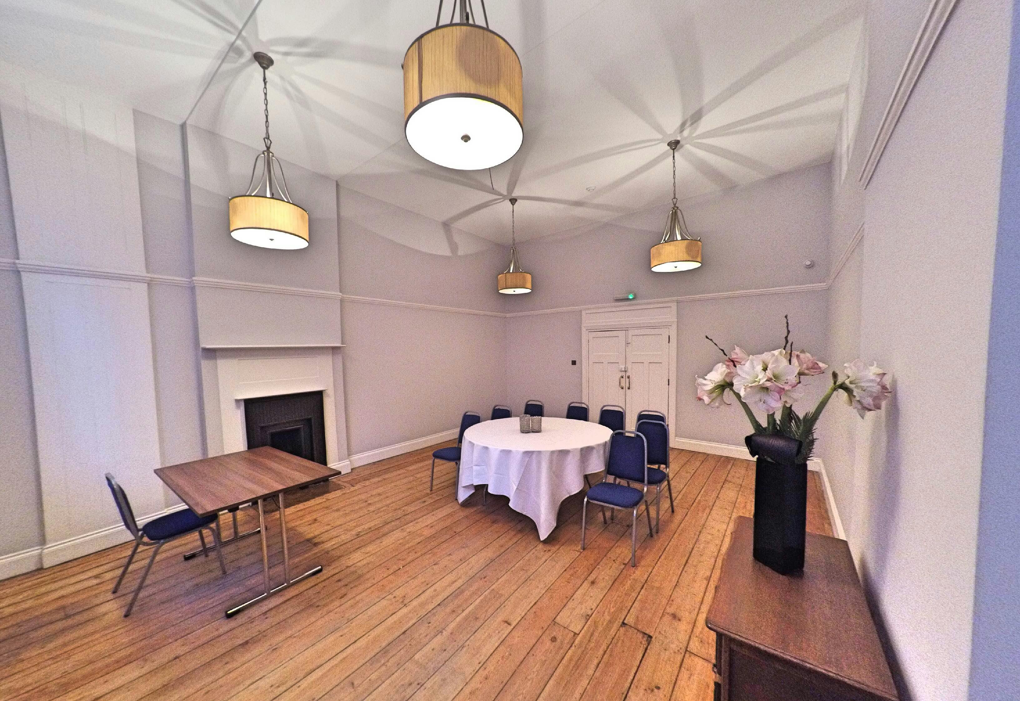 Boardroom at Mary Ward House with round table, ideal for meetings and workshops.