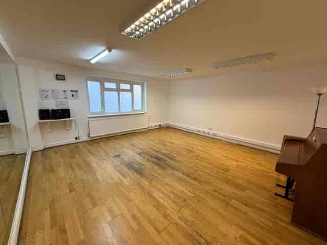 Versatile meeting space with natural light and wooden flooring at The Solo Studio, artsHouse.