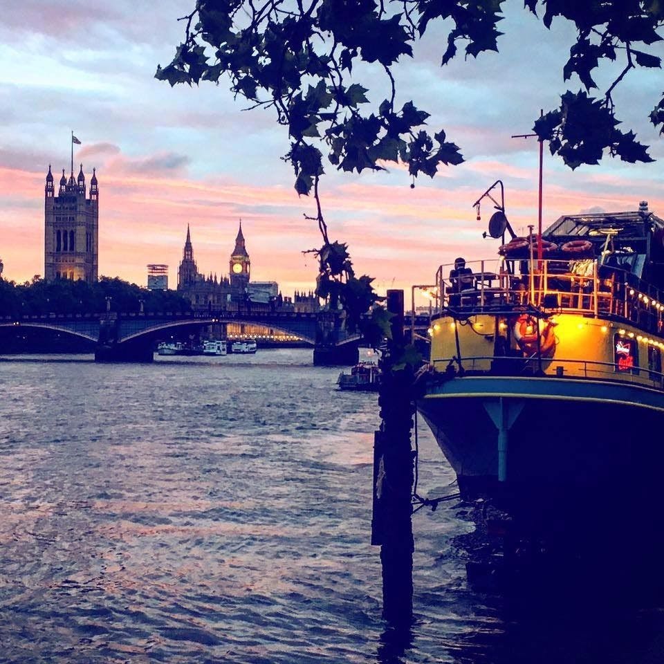 Riverside event venue at Tamesis Dock with sunset backdrop and unique boat setting.