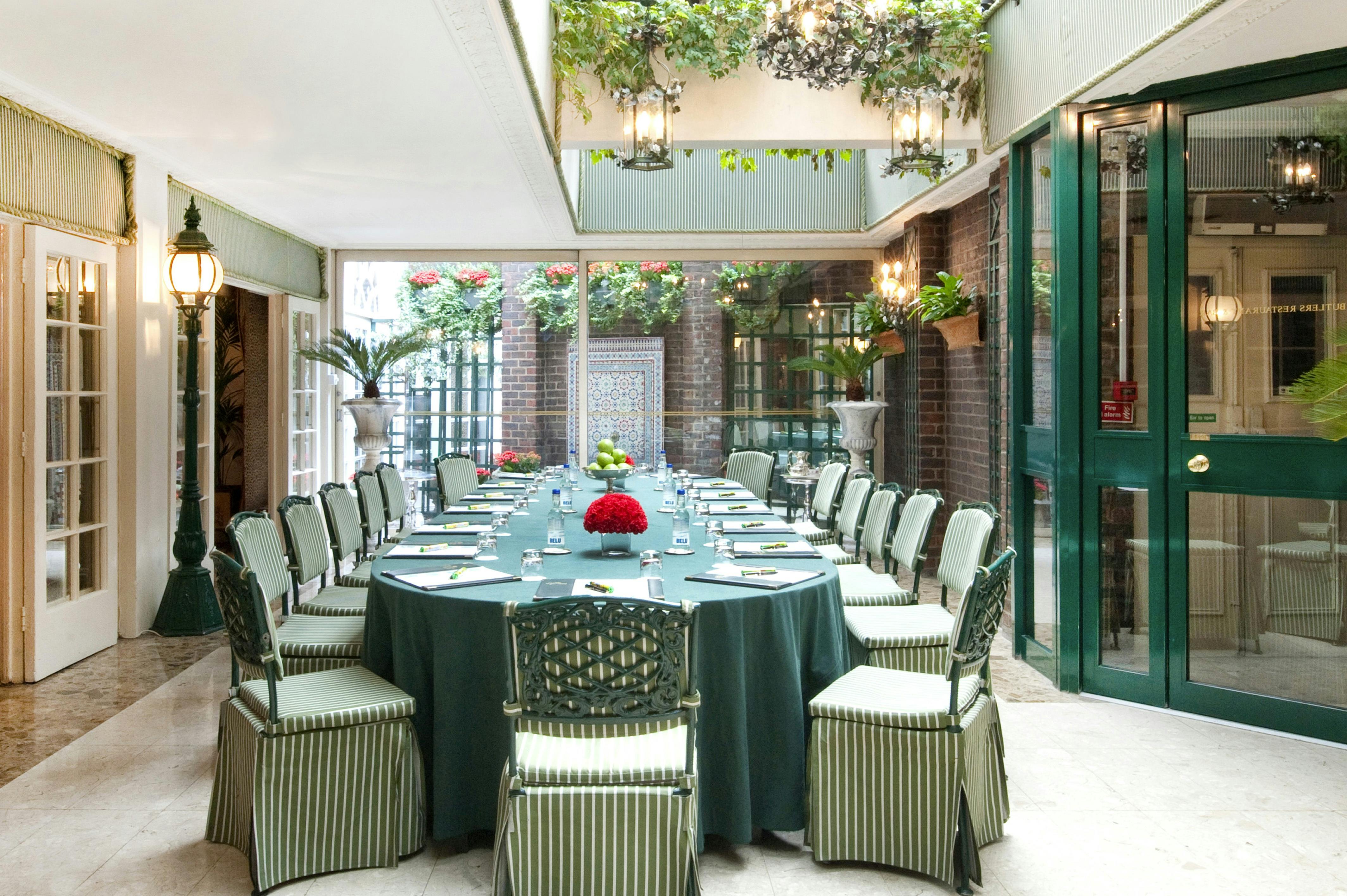 Elegant meeting space at Chesterfield Mayfair Hotel with lush greenery for corporate events.