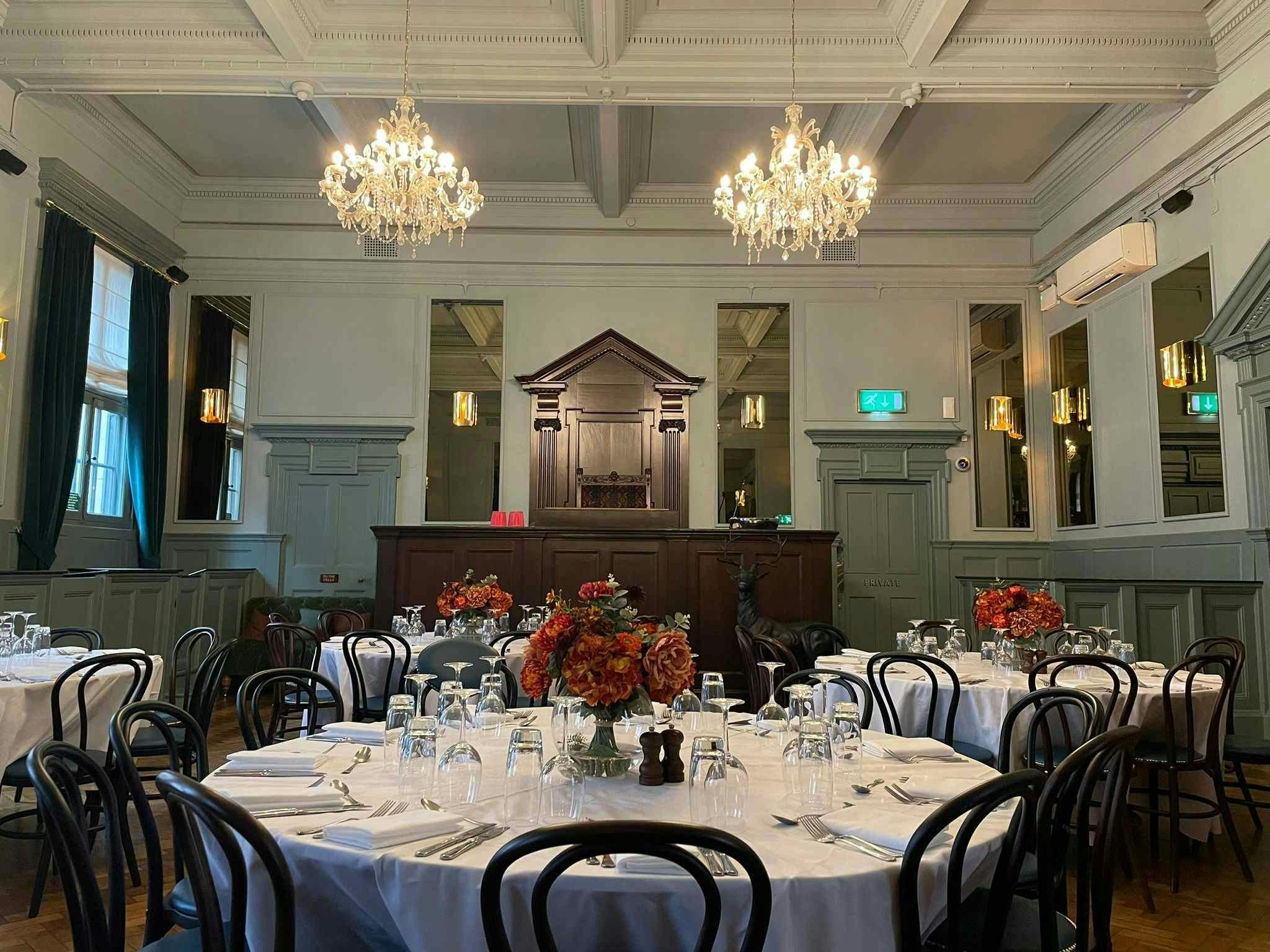 Elegant event space at Spey Bar, featuring chandeliers and ideal for corporate gatherings.