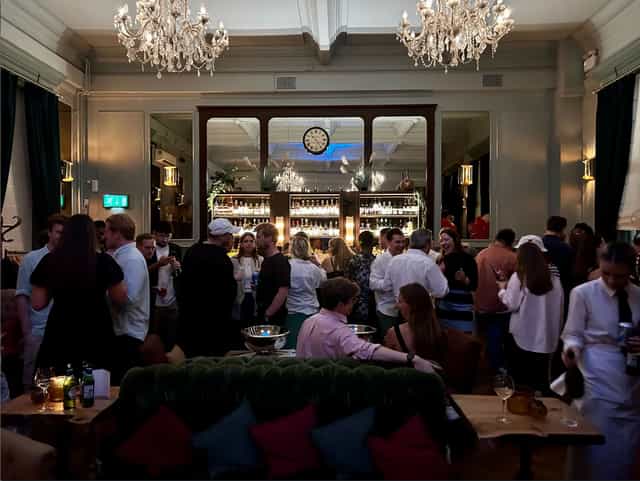 Vibrant networking event at Spey Bar, Browns Covent Garden with elegant decor and chandeliers.
