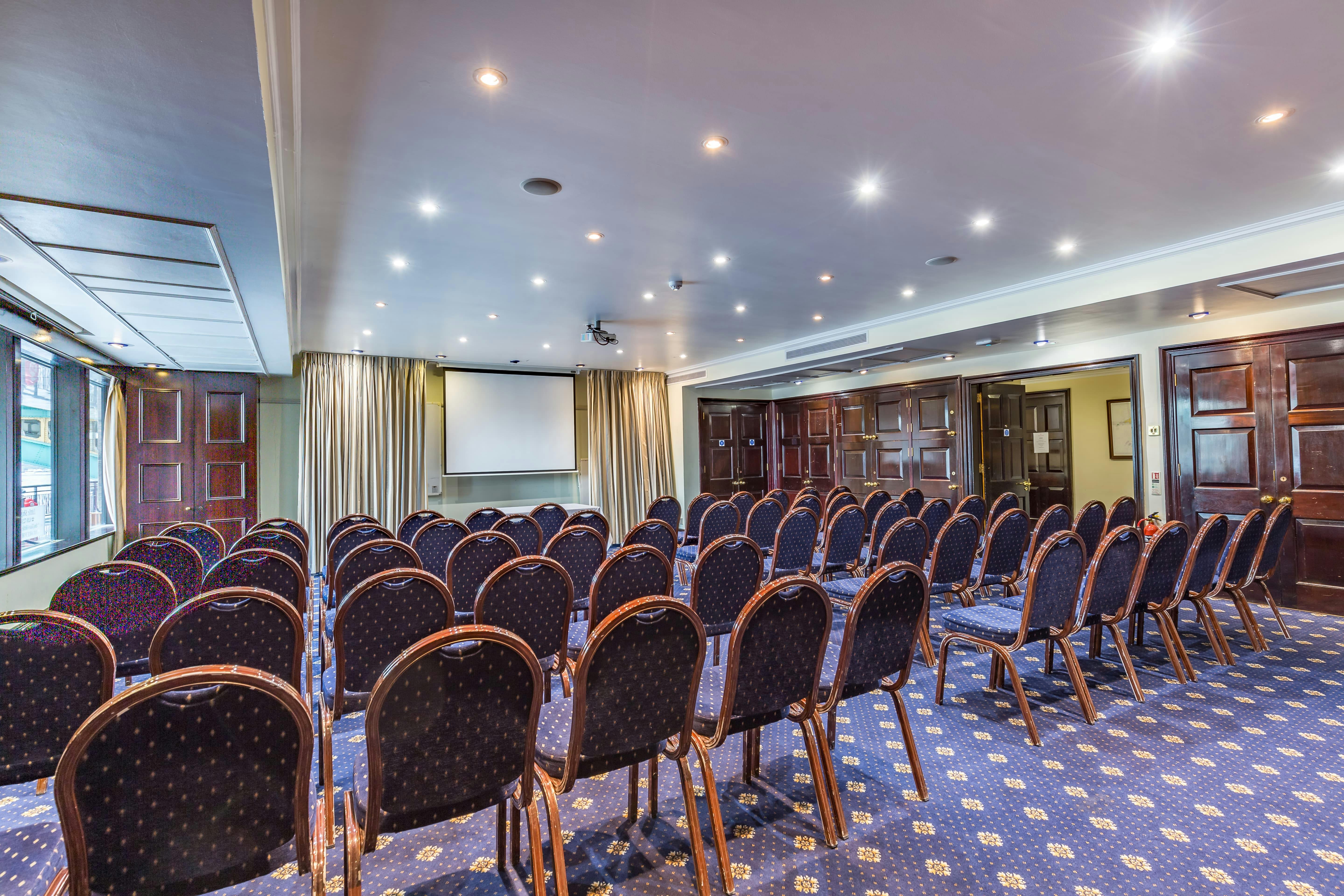 Club Library meeting room with projector, ideal for corporate events and workshops.