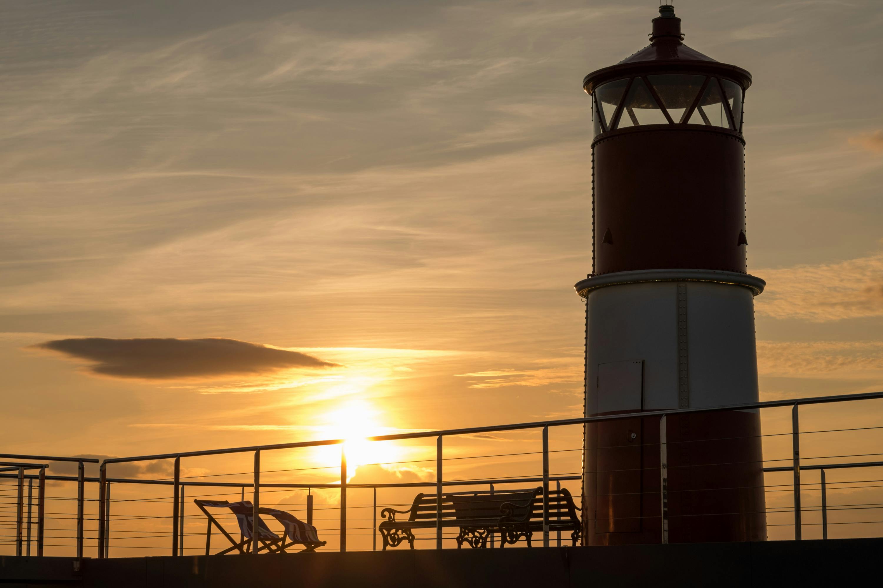 Lighthouse silhouette at sunset in Spitbank Fort's Courtyard for outdoor events.