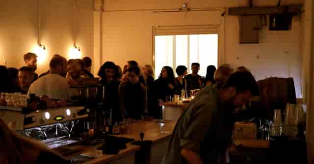 Lively coffee shop gathering with warm lighting, perfect for networking events.