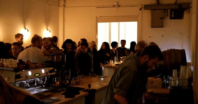 Lively coffee shop gathering with warm lighting, perfect for networking events.