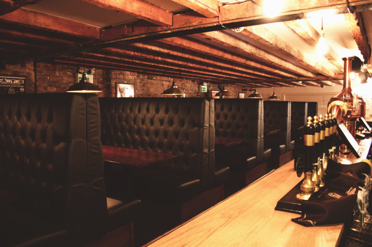 Stylish Stocks Bar at New Cross Inn with leather booths for private events and networking.